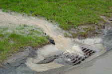 Photo of very dirty stormwater gong down storm drain